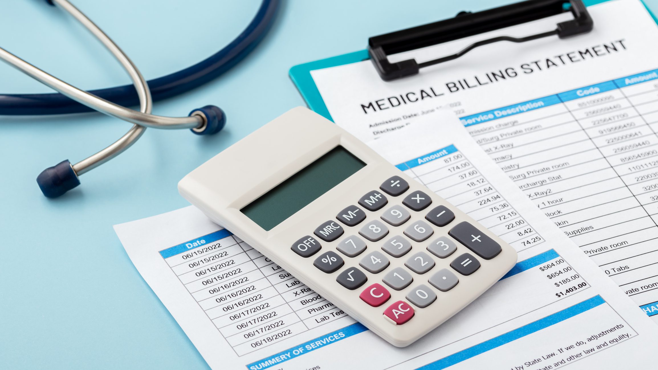 Calculator on medical billing statement with stethoscope.